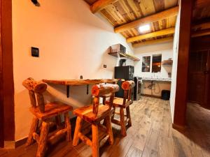 a kitchen with a table and chairs in a room at Cabañas Villa Escondida in Urique