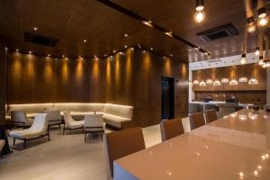 a restaurant with tables and chairs and a gold wall at Unique (Ex-Estanconfor) veja o mar do apto 703 in Santos +20 photos