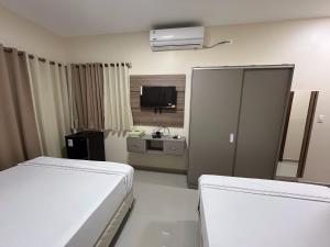 Ένα ή περισσότερα κρεβάτια σε δωμάτιο στο Darling Hotel Ciudad del Este