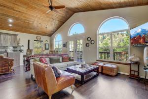 a living room with a couch and a table at Potter's Peak Garden of the Gods Hot Tub Firepit in Cascade-Chipita Park