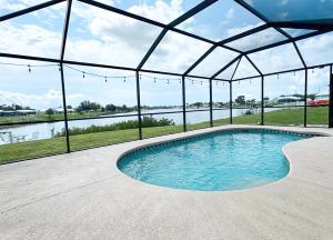a swimming pool in a tent with a view of a river at Experience Fun Starts Here w Pool & Wifi in Port Charlotte