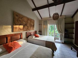 a bedroom with two beds and a window at Villa San Juan, playa Costa Azul in Acajutla +38 photos