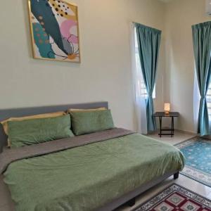 a bedroom with a large green bed with blue curtains at Sri Keroma Bajandoh Muar Homestay in Muar