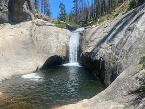 a small waterfall in a large rock formation at Walnut Grove 2BD 1Bath in Oakhurst