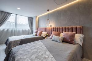 Postel nebo postele na pokoji v ubytování Hotel Glow Medellín