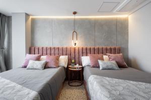 Postel nebo postele na pokoji v ubytování Hotel Glow Medellín