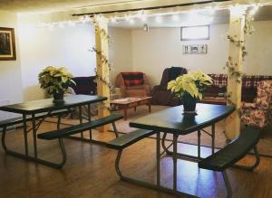 two tables with flowers on them in a living room at Spillover Motel and Inn in Stratton