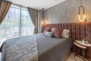 Postel nebo postele na pokoji v ubytování Hotel Glow Medellín