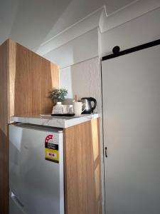 a kitchen with a refrigerator and a counter top at Beagle Hotel in Katherine
