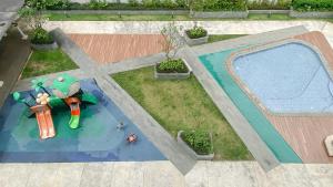 an overhead view of a swimming pool in a backyard at Modern Look Studio Room at Citra Living Apartment By Travelio in Jakarta