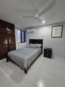 a bedroom with a bed and a ceiling fan at Casa Girasoles Valladolid Yucatán in Santa Bárbara