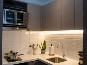 a kitchen with a sink and a microwave at Art Homes 85 in Bogotá +39 photos