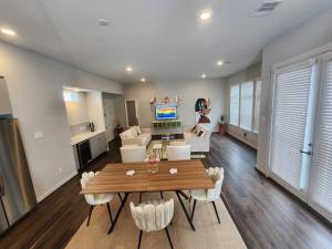 a living room with a table and a couch at Galleria Premium 3 Story Home Sleeps 8 in Houston +31 photos
