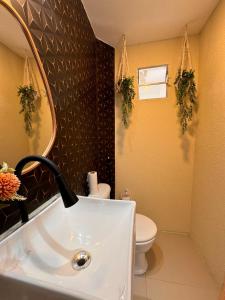 a bathroom with a sink and a toilet at Pousada Costamar in Maragogi +42 photos