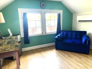 a blue couch in a living room with a window at Cozy Studio Loft Near Downtown in Columbus