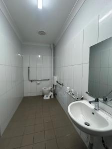 a bathroom with a sink and a toilet in it at Beagle Hotel in Katherine +16 photos