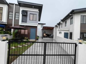 a view of a house with a fence at Phirst Batulao Staycation in Tagaytay