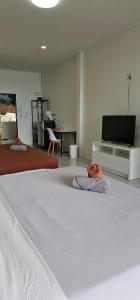 a bedroom with a bed and a flat screen tv at Viking Holiday Resort in Ko Samed