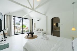 a white bedroom with a teddy bear sitting on a bed at Stunning Pool Villa - In Old Town Chiang Mai Daily Housekeeping in Chiang Mai +68 photos