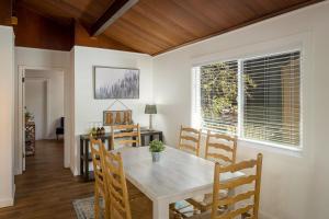a dining room with a white table and chairs at The Brook Ave Bungalow in Kings Beach