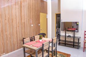 a dining room with a table and chairs at T-Wicks Holiday Apartments in Sigatoka