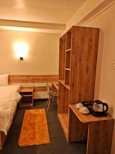 a hotel room with a bed and a desk and a desk at Mudita Stays in Darjeeling