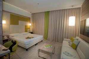 A bed or beds in a room at AS Hotel Limbiate Fiera