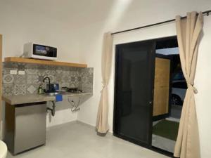 a kitchen with a counter and a sink and a window at MaderoAzul in La Paz