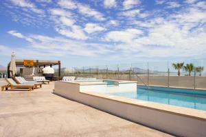 a swimming pool on the roof of a building at Aventuras Hotel in Loreto