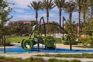 a playground in a park with palm trees at 2 Bedroom Luxury Irvine Portola Springs Home in East Irvine