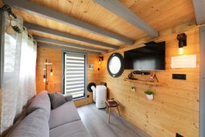 a living room with a couch and a flat screen tv at Chez Mado in Frémifontaine