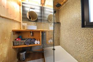 a shower in a bathroom with a glass shower stall at Chez Mado in Frémifontaine +55 photos