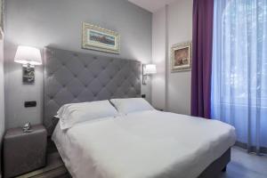 Postel nebo postele na pokoji v ubytování Hotel Moderno