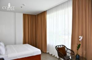 Postel nebo postele na pokoji v ubytování Coast Wise Hotel Dumaguete + 12 fotografií
