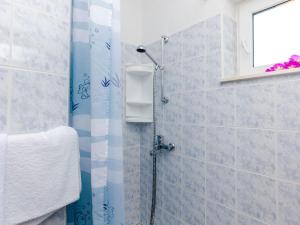 a bathroom with a shower with blue tiles at Apartments Cypress Sea Cove - Comfort Studio Apartment with Balcony and Sea View A1 in Slano