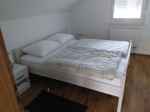 a white bed in a room with a window at Holiday Home Gra ec - Three Bedroom Holiday Home with swimming pool in Zagreb