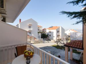 a basket of fruit on a table on a balcony at Apartments Senjo - Studio Apartment with Balcony with Side Sea View Apartman 4 in Cavtat