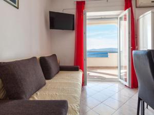 a living room with a couch and a view of the ocean at Apartments Nena ST - Two Bedroom Apartment with Terrace and Sea View A3 in Pisak