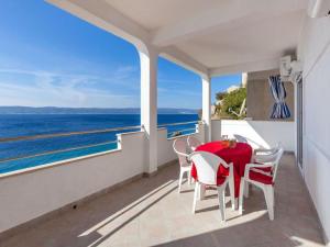 a balcony with a table and chairs and the ocean at Apartments Nena ST - Two Bedroom Apartment with Terrace and Sea View A3 in Pisak