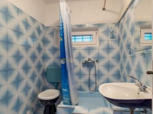 a blue tiled bathroom with a sink and a shower at Apartments Nena ST - Two Bedroom Apartment with Terrace and Sea View A3 in Pisak +8 photos