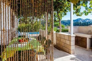 a bathroom with a view of a tub and a sink at Green Garden House - Four Bedroom House with Private Pool in Žrnovo