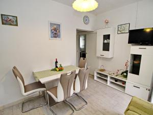 a kitchen and dining room with a table and chairs at Green Garden House - Four Bedroom House with Private Pool in Žrnovo