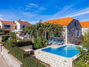 a swimming pool in front of a house at Green Garden House - Four Bedroom House with Private Pool in Žrnovo