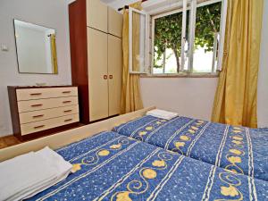 a bedroom with two beds and a dresser and a window at Green Garden House - Four Bedroom House with Private Pool in Žrnovo +37 photos