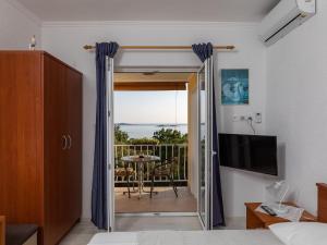 a bedroom with a sliding glass door leading to a balcony at Apartments Belenum - One-Bedroom Apartment with Balcony and Sea View no 3 in Mlini