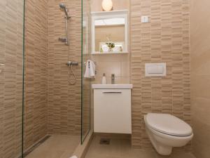 a bathroom with a toilet and a shower at Villa LA-Comfort One Bedroom Apartment with Sea View Terrace 1 in Veliki Drvenik +28 photos
