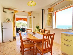 a kitchen and dining room with a table and chairs at Apartments Sea Line - One Bedroom Apartment with Terrace and Sea View in Prigradica +7 photos