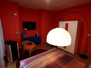 Un dormitorio con una habitación roja con una cama y una lámpara en Andres Guest house Sanremo, en San Remo