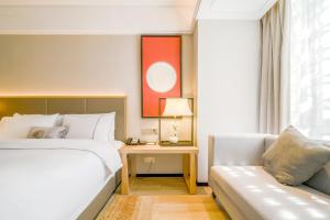 Nanning Vientiane City Convention and Exhibition Center Yicheng Hotel客房内的一张或多张床位