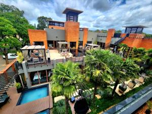 an aerial view of a building with a woman sitting on the balcony at Fusion Boutique Hotel in Polokwane